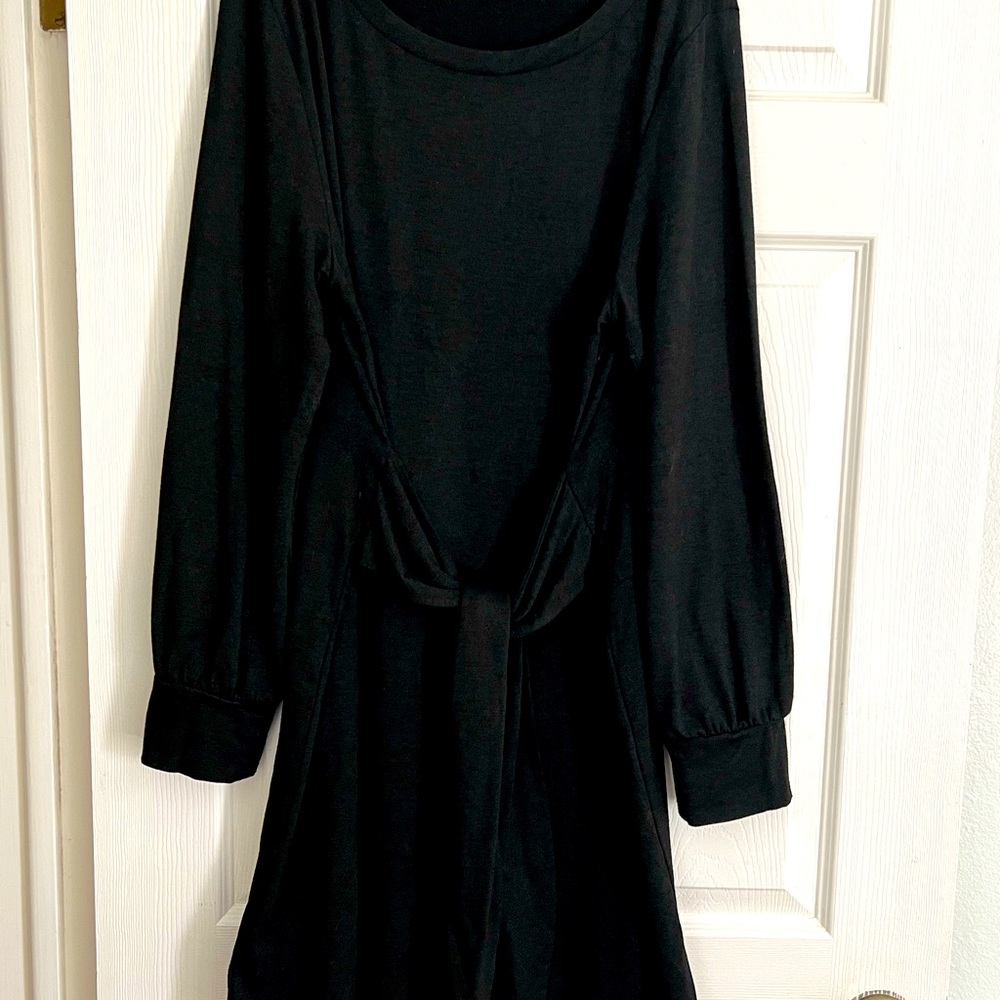 Long sleeved black dress. Material is 65% rayon, 27% polyester, and 8% spandex.